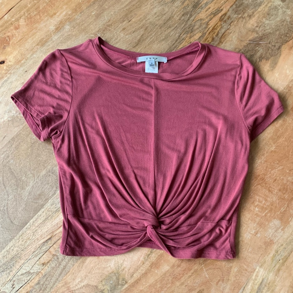 Rust colored crop top with a tied knot look in the front